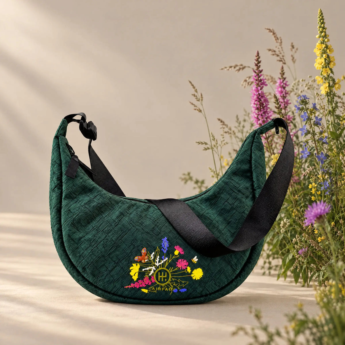 Moonbaq 9L Robinga-Edition Auflage 2 – Frontansicht auf sandfarbenem Hintergrund mit Wildblumen